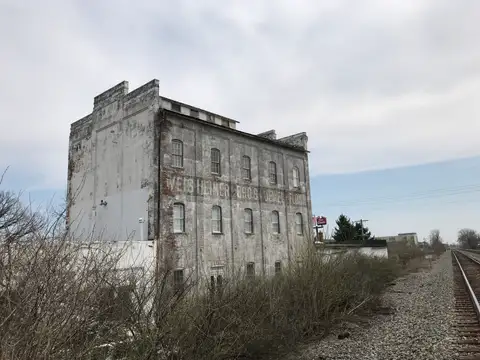 Time-worn walls tell tales by the tracks.